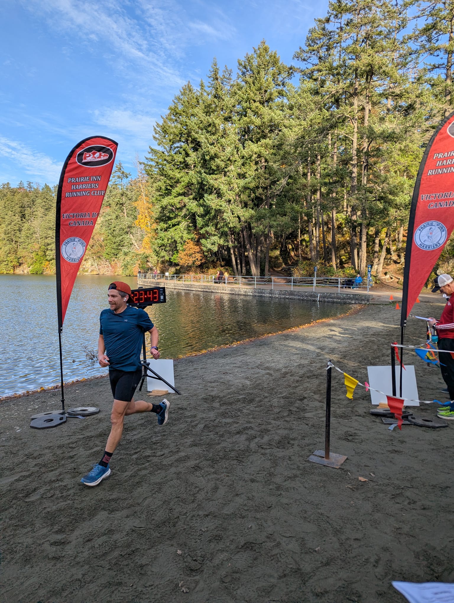 Jacob Haas crossing finish line at trail race on sandy beach Vancouver Island BC